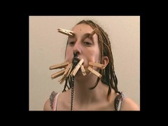 Both girl with clothes pins on her face clip