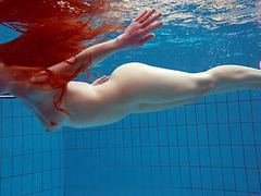 Redhead simonna showing her body underwater tubes