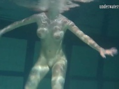 Naked brunette with big tits swims solo movies at freekilomovies.com