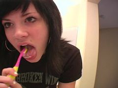 Andi brushes her teeth and sticks out her tongue clip