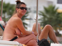 Cute milfs tanning topless on a beach vacation