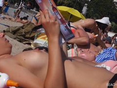Topless tanning girls both have sexy amateur tits