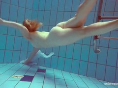 Redhead goes for a nude swim in the pool videos