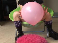 AlphaErotic presents: Babe in black leather boots pops balloon