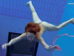 TubeChubby presents: Curly hair redhead swims and looks sexy