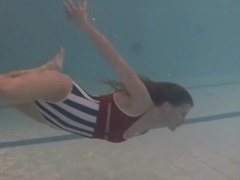 UhPorn presents: Leggy girl swims and strips naked in pool