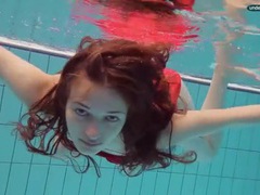 Teen in a pretty red dress slips into the pool