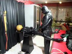 Kinky latex and leather play in dungeon