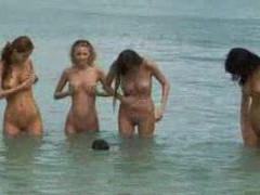Four naked and perfect girls at the beach