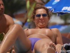 KiloLesbians presents: Topless milf gets some sun in the sand