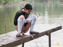 Public pissing girl in jeans goes in two places